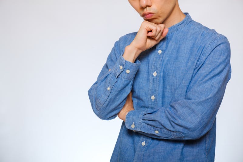 男性が顎に手をあて、考えている様子